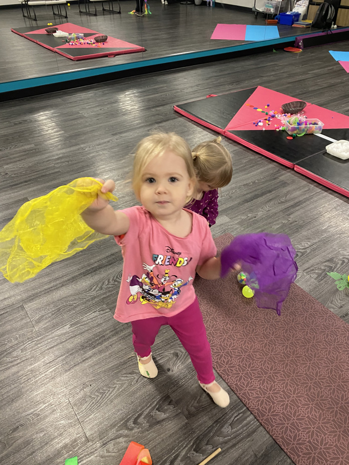 kid holding yellow silk cloth