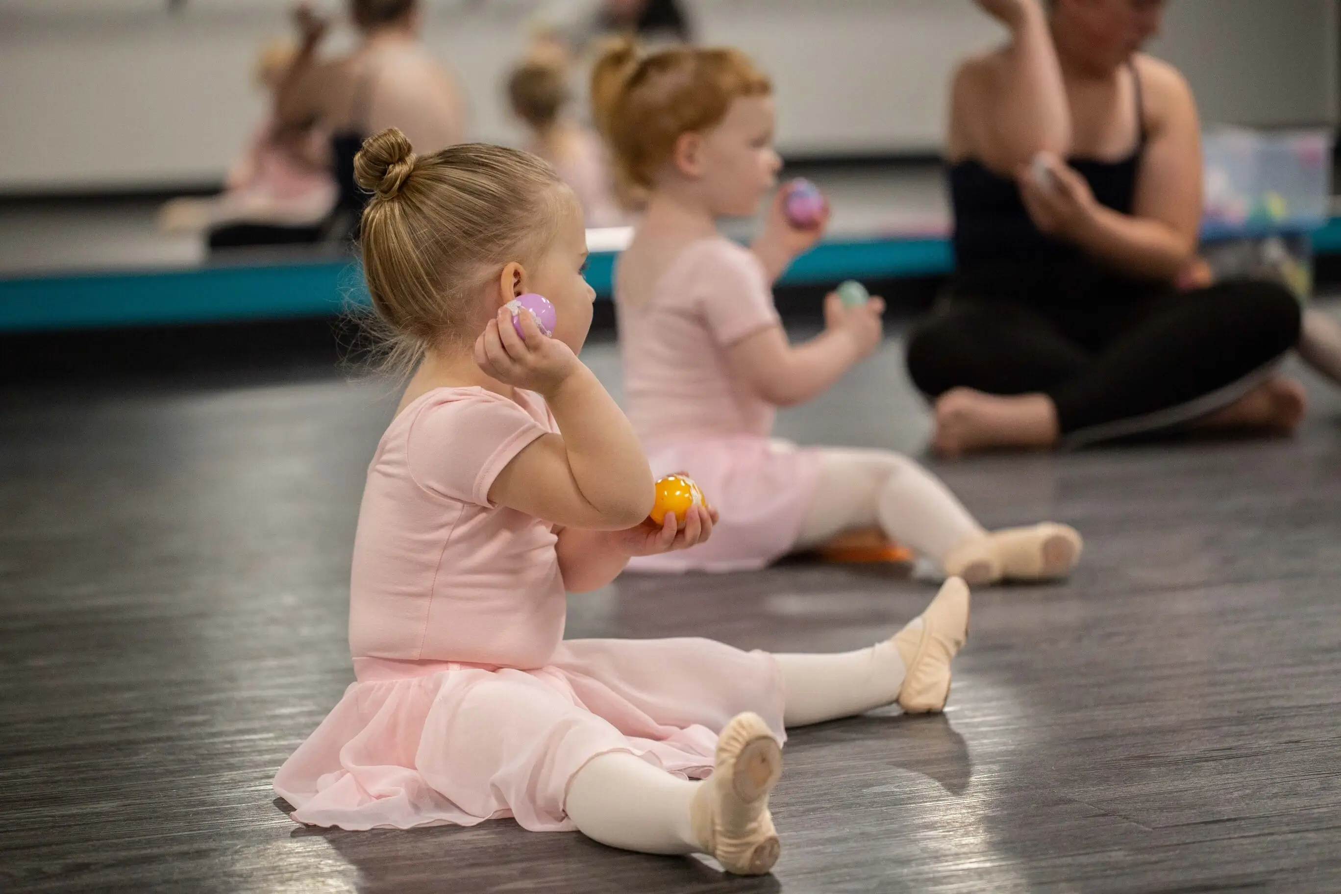 pre-k baby wearing pink ballet dress